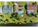 Aerial view of a lakeside home with a private dock and screened in pool with solar panels on the roof at 3381 Conway Blvd, Port Charlotte, FL 33952