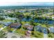 Aerial view of a waterfront community with houses on a canal leading to a bay at 3381 Conway Blvd, Port Charlotte, FL 33952