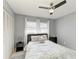 Bedroom with ceiling fan, shutters, white linens, and a comfortable setting in a neutral palette at 3381 Conway Blvd, Port Charlotte, FL 33952