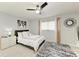 Relaxing bedroom featuring neutral tones, a decorative mirror, and a textured rug at 3381 Conway Blvd, Port Charlotte, FL 33952