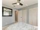 Bright bedroom featuring bi-fold closet doors and a neutral palette, complete with a ceiling fan at 3381 Conway Blvd, Port Charlotte, FL 33952