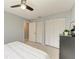 Bright bedroom featuring bi-fold closet doors and a neutral palette with tiled floors at 3381 Conway Blvd, Port Charlotte, FL 33952