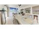 Open-concept dining area that showcases the beautiful beach mural, access to the kitchen and living room at 3381 Conway Blvd, Port Charlotte, FL 33952