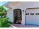 Close up of a well kept house entrance and two car garage on the right at 3381 Conway Blvd, Port Charlotte, FL 33952