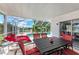 Screened patio with a dining set and lounge chairs, offering views of the inviting pool and garden at 3381 Conway Blvd, Port Charlotte, FL 33952
