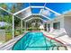 Enjoy the crystal-clear waters of this screened pool, easily accessible with convenient steps and surrounded by serene greenery at 3381 Conway Blvd, Port Charlotte, FL 33952