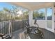 Covered balcony with exercise equipment and views of the trees at 3553 Secluded Ct, Sarasota, FL 34240