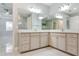 Bathroom view highlighting a dual-sink vanity with stone countertops, mirrors, and walk-in shower at 3553 Secluded Ct, Sarasota, FL 34240