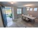 Bright dining room featuring gray walls, recessed lighting, and a chandelier, with a view from the entryway at 3553 Secluded Ct, Sarasota, FL 34240