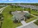 Aerial view of a community center with a playground, picnic area, and a large grassy field perfect for outdoor activities at 3553 Secluded Ct, Sarasota, FL 34240