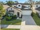 Charming two-story home with stone accents, a well-manicured lawn, and a two-car garage at 3553 Secluded Ct, Sarasota, FL 34240