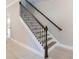 Staircase with white risers and decorative, wrought-iron balusters at 3553 Secluded Ct, Sarasota, FL 34240