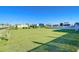 Large grassy backyard with trimmed shrubs near community at 37530 Corey Lewis Ave, Zephyrhills, FL 33541