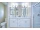 Bright bathroom featuring a double vanity with white cabinets and a large framed mirror at 37530 Corey Lewis Ave, Zephyrhills, FL 33541
