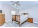 Traditional bedroom with wood furniture, a ceiling fan, and light gray wood-look flooring at 37530 Corey Lewis Ave, Zephyrhills, FL 33541