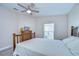 Bedroom with wooden bed frame, ceiling fan, and a window with vertical blinds at 37530 Corey Lewis Ave, Zephyrhills, FL 33541