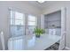 Bright dining area featuring a white table with a plant centerpiece and a laundry closet at 37530 Corey Lewis Ave, Zephyrhills, FL 33541