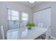 Light-filled dining space with modern table set and window views, near a closet at 37530 Corey Lewis Ave, Zephyrhills, FL 33541