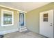 Welcoming porch featuring a blue door, side window, and a secondary access point at 37530 Corey Lewis Ave, Zephyrhills, FL 33541
