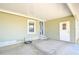 Covered entrance featuring a stylish blue door, storm door, and adjacent storage or utility access at 37530 Corey Lewis Ave, Zephyrhills, FL 33541