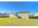Green sided home with a well maintained lawn, brick foundation and an air conditioning unit at 37530 Corey Lewis Ave, Zephyrhills, FL 33541