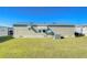 Well-maintained home exterior with green siding and manicured lawn, ready for outdoor living at 37530 Corey Lewis Ave, Zephyrhills, FL 33541