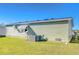 Exterior shot showing a green sided house with a well maintained lawn and AC unit at 37530 Corey Lewis Ave, Zephyrhills, FL 33541