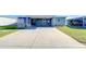Charming single-story home featuring a covered carport, well-maintained lawn, and a welcoming entrance at 37530 Corey Lewis Ave, Zephyrhills, FL 33541