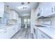Updated kitchen with white cabinets, granite countertop, stainless steel appliances, and an eat-in dining area at 37530 Corey Lewis Ave, Zephyrhills, FL 33541