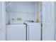 A well-organized laundry room equipped with a white washer and dryer, and wire shelving at 37530 Corey Lewis Ave, Zephyrhills, FL 33541