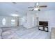 Open-concept living space with new floors, fan, and a view towards the kitchen and front door at 37530 Corey Lewis Ave, Zephyrhills, FL 33541