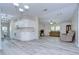 Open-concept living space with new floors, fan, a combined kitchen and sitting area at 37530 Corey Lewis Ave, Zephyrhills, FL 33541