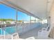 Covered outdoor seating area overlooks a sparkling pool on a sunny day at 37530 Corey Lewis Ave, Zephyrhills, FL 33541