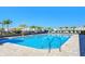 Community pool with lounge chairs, umbrellas, and pool ladder at 37530 Corey Lewis Ave, Zephyrhills, FL 33541