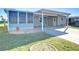Cozy porch area leading to the home, featuring a sheltered entrance and well-manicured surroundings at 37530 Corey Lewis Ave, Zephyrhills, FL 33541