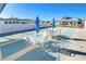 Outdoor shuffleboard court with tables, chairs, and blue umbrellas at 37530 Corey Lewis Ave, Zephyrhills, FL 33541