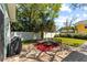Outdoor patio area featuring comfortable seating, a grill, and lush green lawn at 4750 Burlington N Ave, St Petersburg, FL 33713