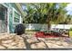 Outdoor patio area featuring comfortable seating, a grill, and lush green lawn at 4750 Burlington N Ave, St Petersburg, FL 33713