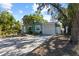 Inviting home with a well-maintained lawn, mature trees, and a covered carport at 4750 Burlington N Ave, St Petersburg, FL 33713