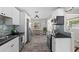 Modern kitchen featuring white cabinets, stainless steel appliances, and stylish backsplash at 4750 Burlington N Ave, St Petersburg, FL 33713