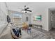 Well-lit living room featuring a comfortable sectional, wood floors, and exterior access at 4750 Burlington N Ave, St Petersburg, FL 33713