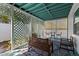 Relaxing screened-in porch with comfortable seating, lattice details, and a decorative rug at 4750 Burlington N Ave, St Petersburg, FL 33713