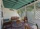 Relaxing screened-in porch with comfortable seating, lattice details, and a decorative rug at 4750 Burlington N Ave, St Petersburg, FL 33713