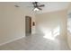 Sunlit living room with tiled floors, a ceiling fan, and a large window creating a welcoming atmosphere at 512 Richmond St, Dunedin, FL 34698