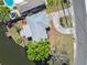 An aerial view of the roof, backyard and dock of the canal-front property in a residential neighborhood at 5167 Venetian Ne Blvd, St Petersburg, FL 33703