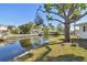 Canal view with lush landscaping, large tree, and waterfront views at 5167 Venetian Ne Blvd, St Petersburg, FL 33703