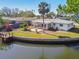 An aerial perspective of a backyard with a dock and an enclosed patio and lawn space near the water at 5167 Venetian Ne Blvd, St Petersburg, FL 33703
