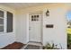 Close-up of the white front door with a window and decorative light fixture, plus classic black mailbox at 5167 Venetian Ne Blvd, St Petersburg, FL 33703