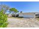 A single-story house features an attached two-car garage and a concrete driveway at 5167 Venetian Ne Blvd, St Petersburg, FL 33703