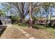 Spacious backyard featuring mature trees, a screened-in porch, a swing set and hammock at 592 Deer W Run, Palm Harbor, FL 34684